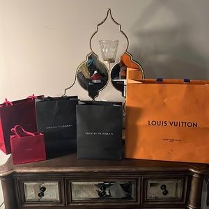 Cartier, David Yurman and Louis Vuitton shopping bags